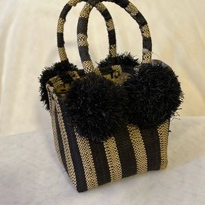 Schooner Straw Mini Bag with Pompom Accent black and tobacco stripes.
